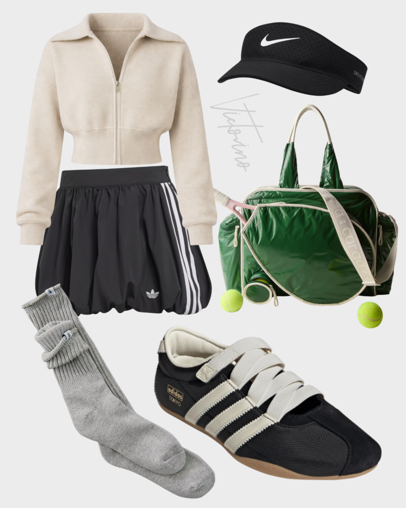 Flat lay fashion collage including an oatmeal cropped zip jacket, black Adidas balloon skirt, black Nike visor, glossy green Caraa duffle bag, grey scrunch socks, and black and white Adidas Tokyo sneakers on a grey background.